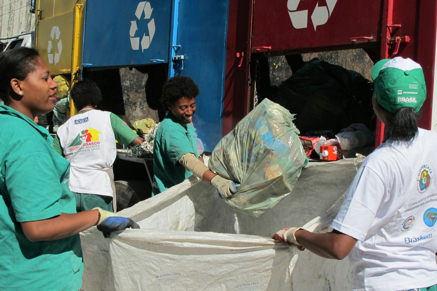 Members of a recycling cooperative sorting materials